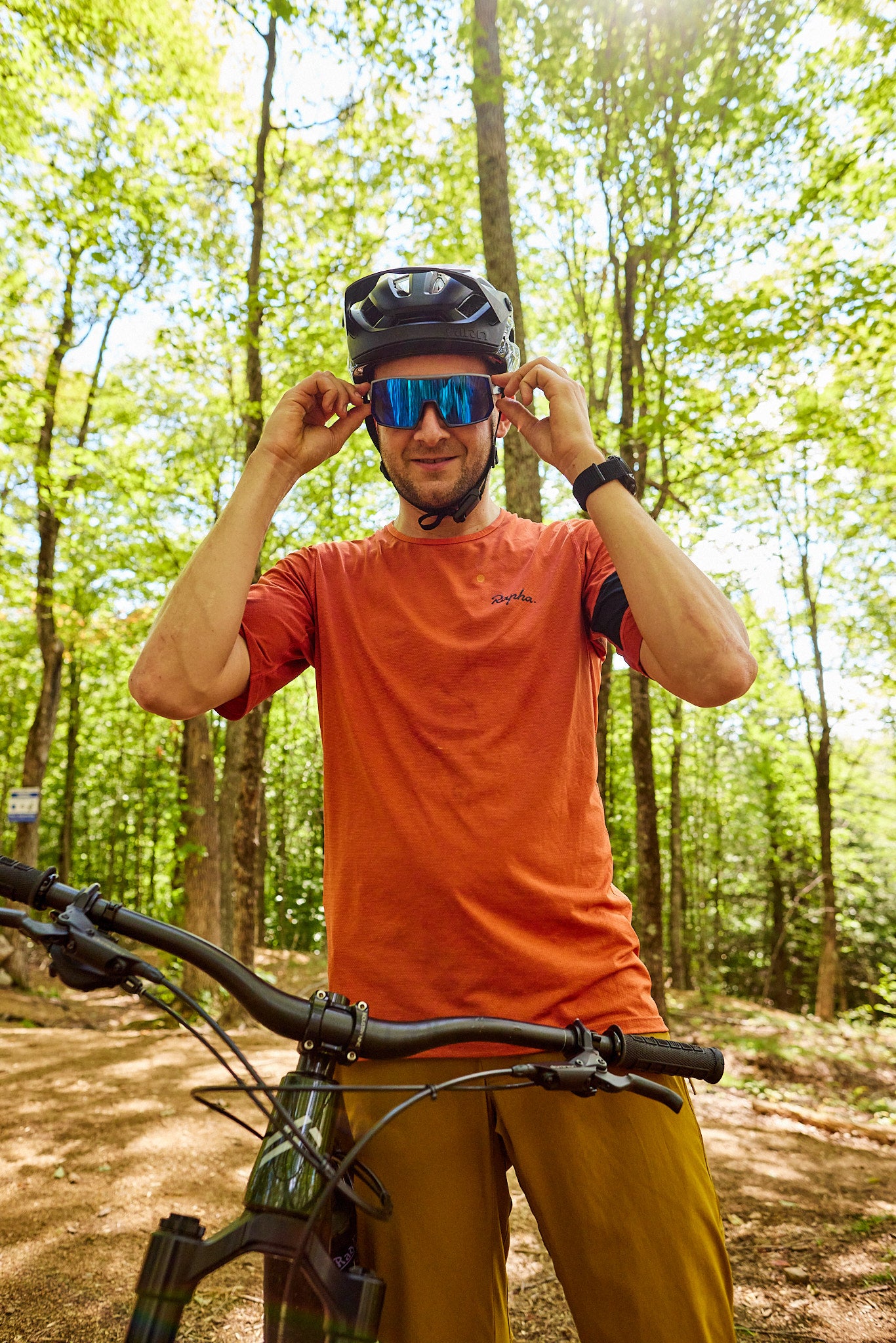 man wearing uvex sportstyle 235 sunglasses with a bike helmet