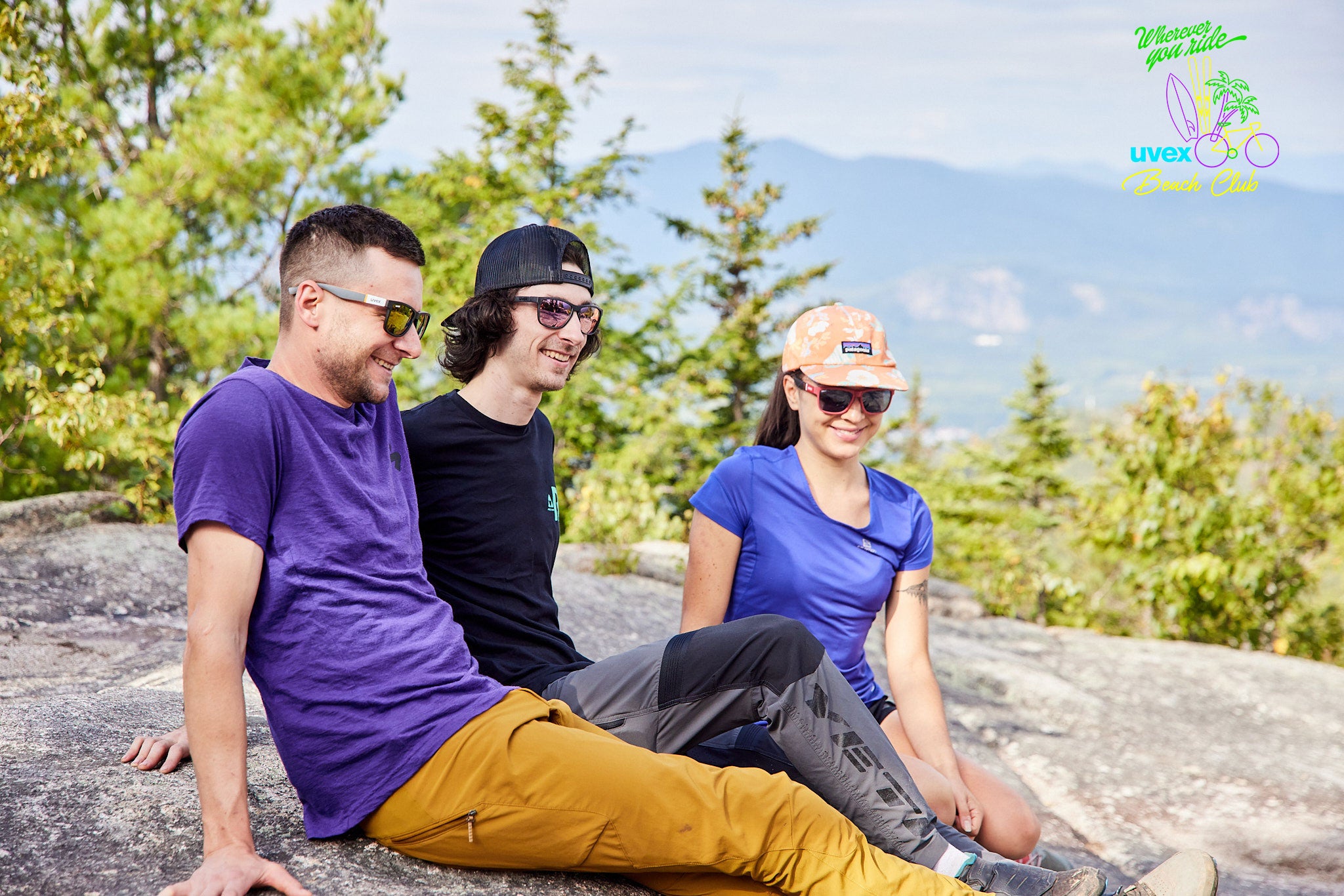 Three friends on a rock in sunglasses