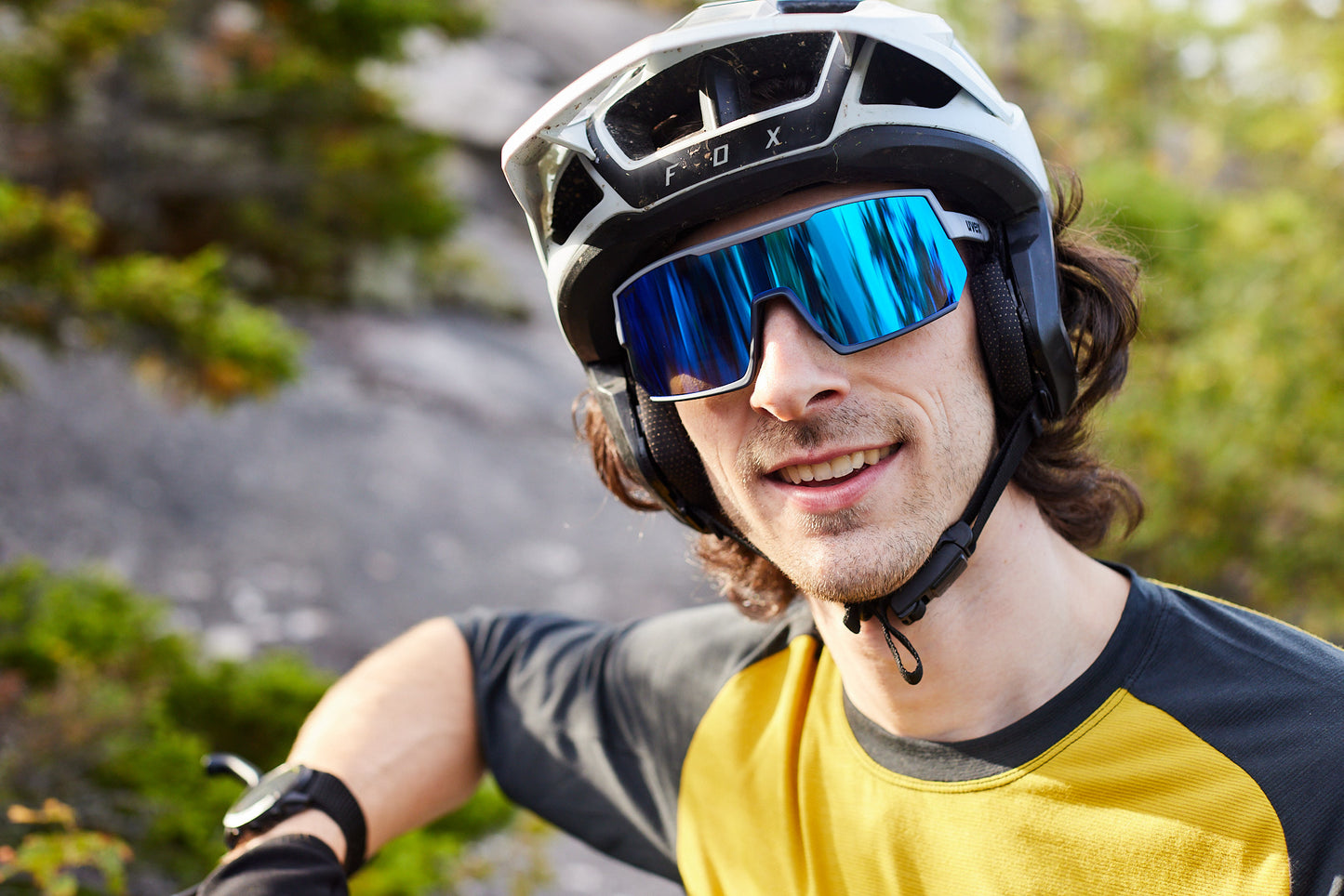 man wearing uvex sportstyle 235 sunglasses and a bike helmet