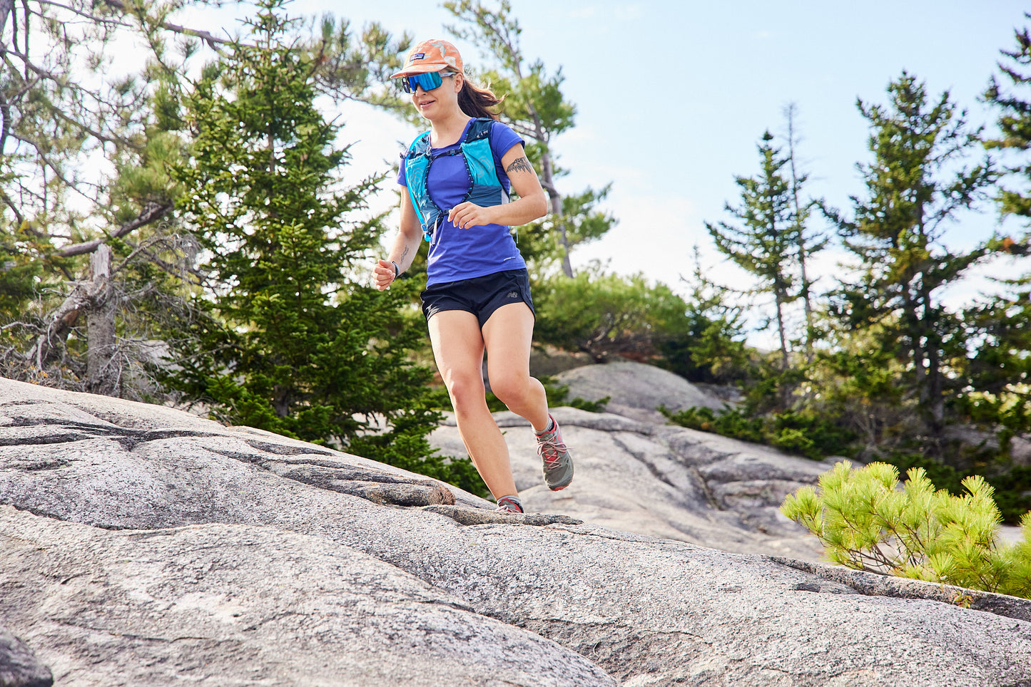 woman trail running while wearing uvex sportstyle 235 sunglasses