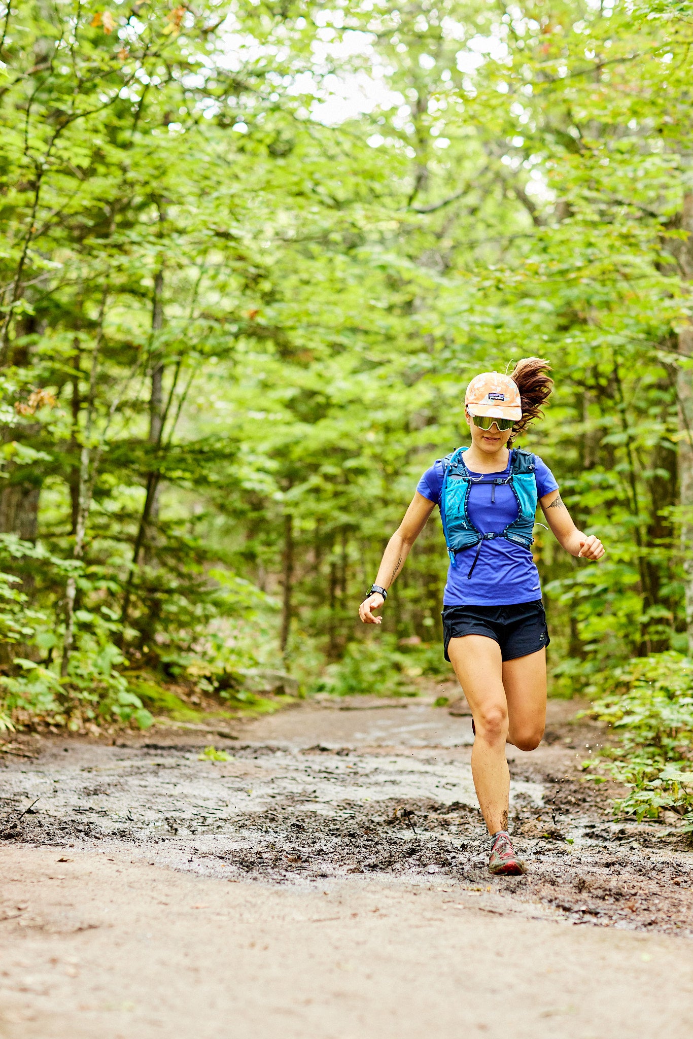 woman trail running wearing uvex sportstyle 236 sunglasses