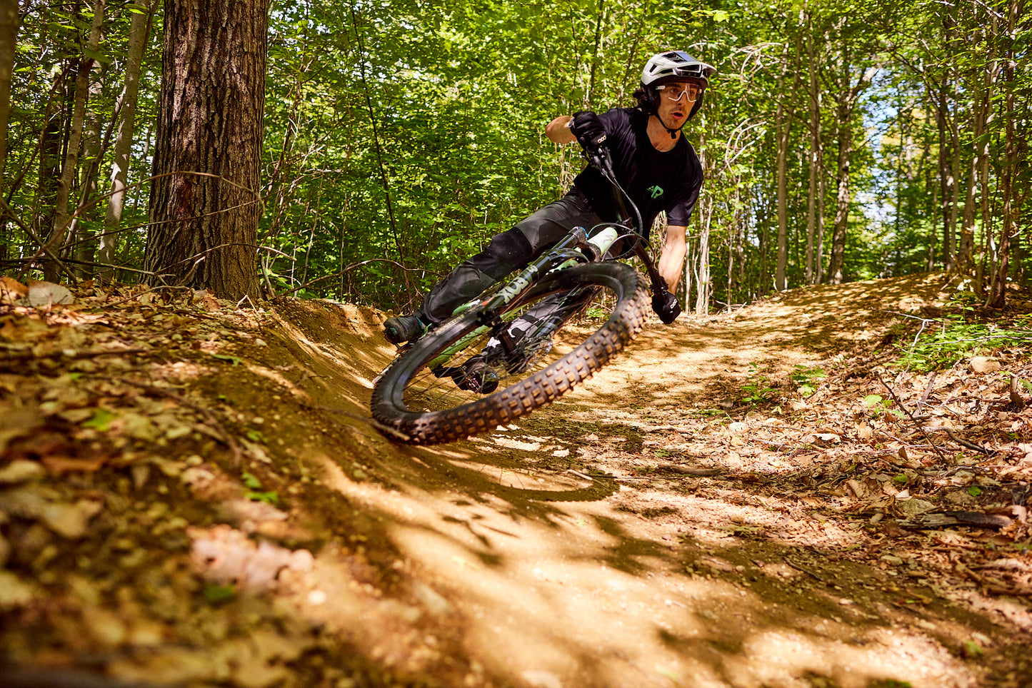 a mountain biker wearing uvex sportstyle 236 s sunglasses with a clear lense